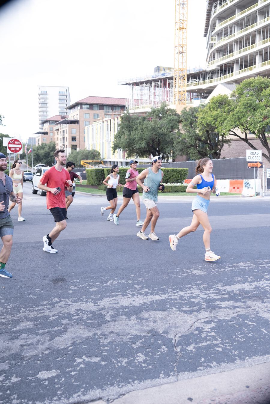 Runners crossing a street near the UT campus
